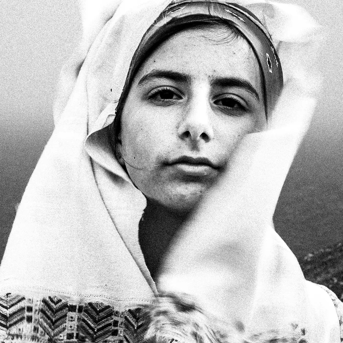 Black and White Photography Wall Art Greece | Girl wearing the traditional costume of Tilos island at a windy cliff Dodecanese Greece by George Tatakis - detailed view
