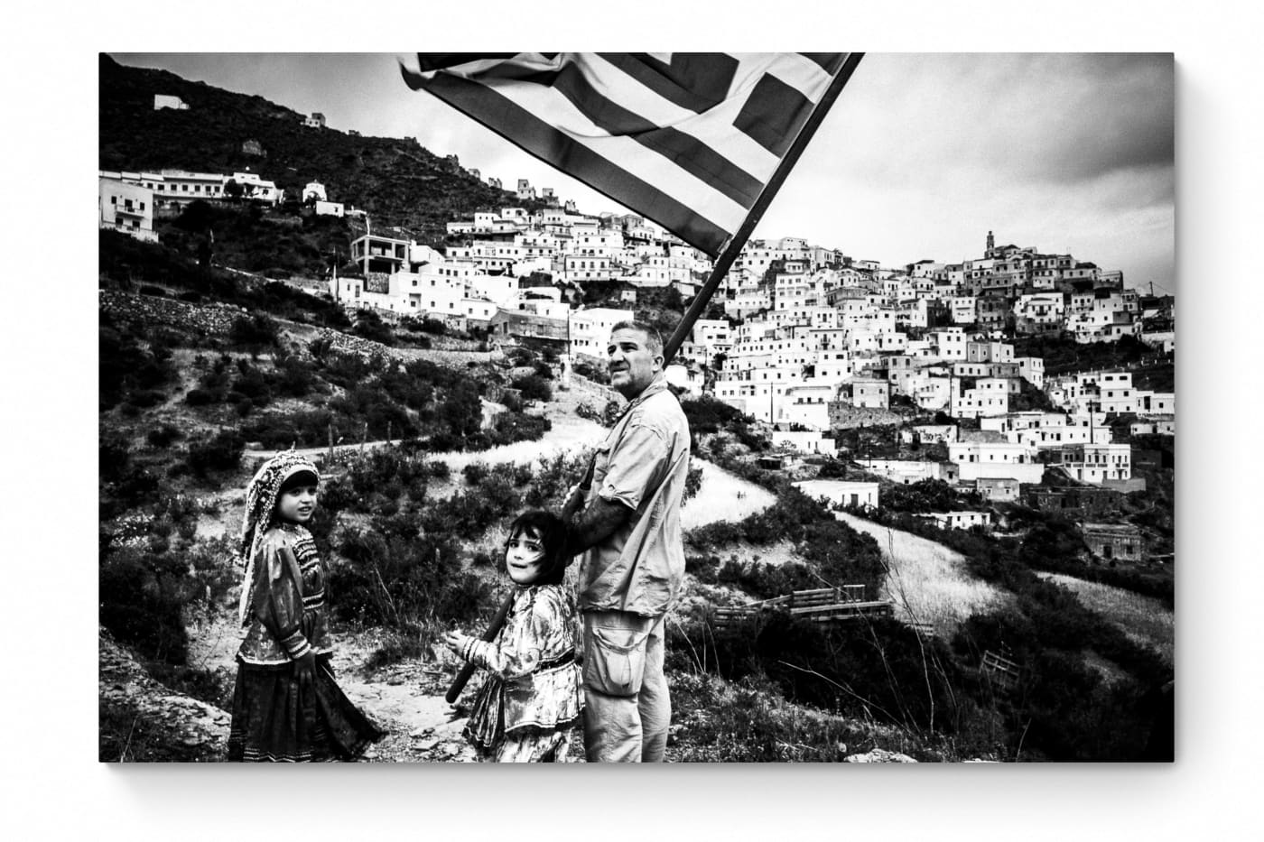 Black and White Photography Wall Art Greece | Carrying the Greek flag in Olympos Karpathos Dodecanese by George Tatakis - whole photo