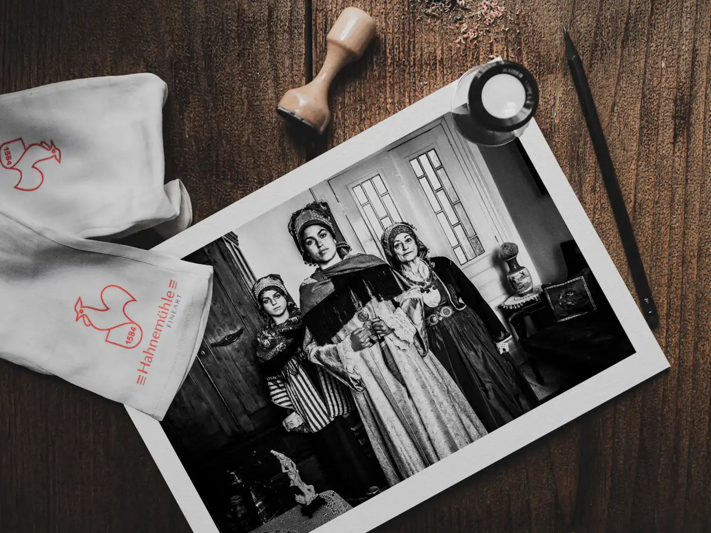 Black and White Photography Wall Art Greece | Three ladies in the traditional costumes of Symi island inside a house Dodecanese Greece by George Tatakis - photo print on table