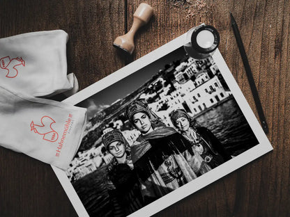 Black and White Photography Wall Art Greece | Three ladies on a boat in the traditional costumes of Symi island Dodecanese Greece by George Tatakis - photo print on table