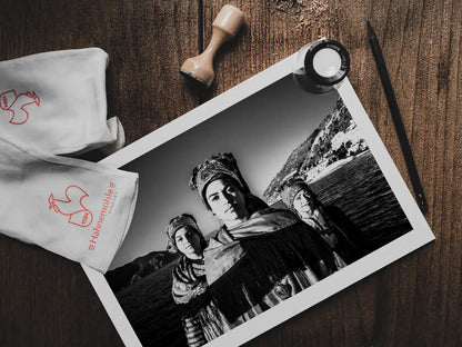 Black and White Photography Wall Art Greece | Three ladies on a boat in the traditional costumes of Symi island Dodecanese Greece by George Tatakis - photo print on table