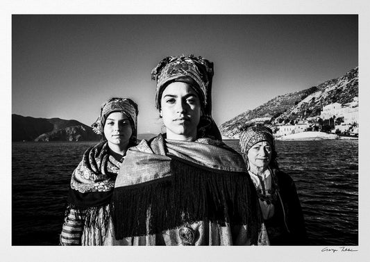 Black and White Photography Wall Art Greece | Three ladies on a boat in the traditional costumes of Symi island Dodecanese Greece by George Tatakis