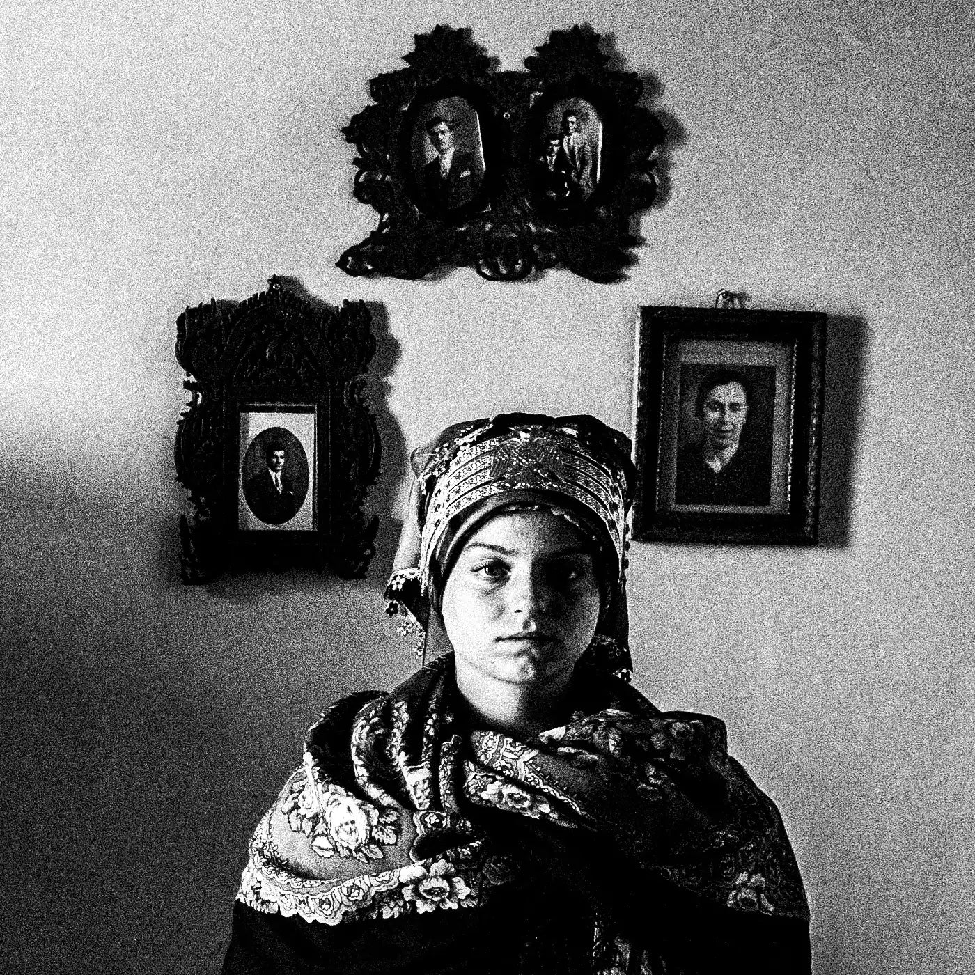 Black and White Photography Wall Art Greece | Three ladies in the traditional costumes of Symi island inside a room with frames Dodecanese by George Tatakis - detailed view