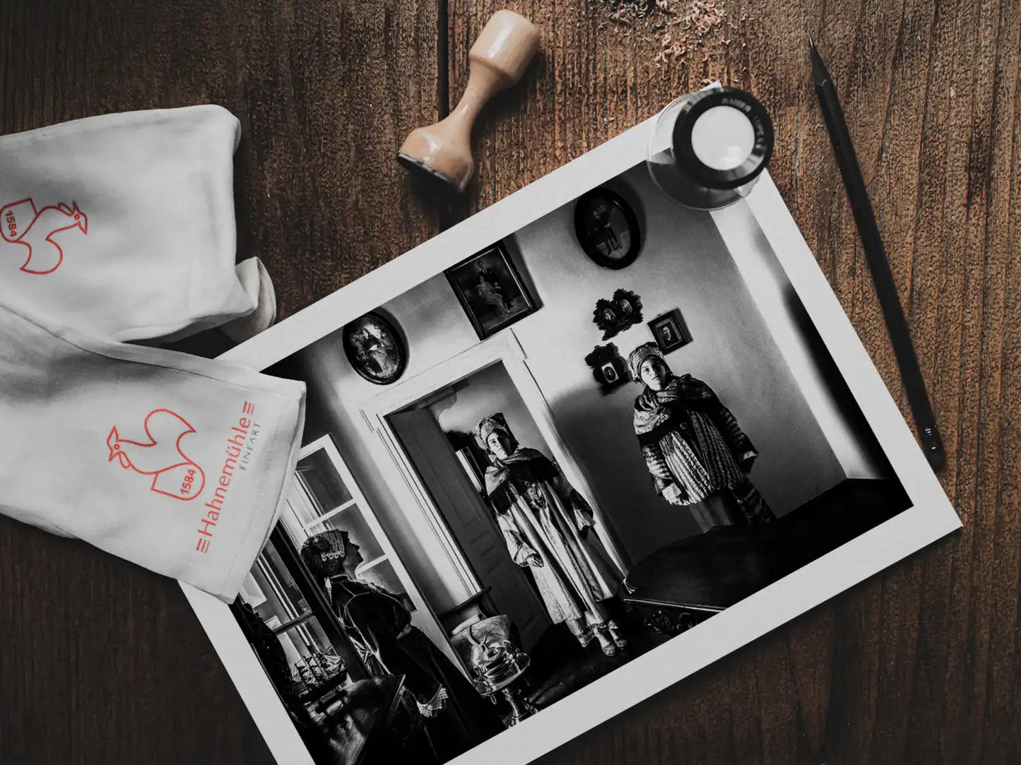 Black and White Photography Wall Art Greece | Three ladies in the traditional costumes of Symi island inside a room with frames Dodecanese by George Tatakis - photo print on table