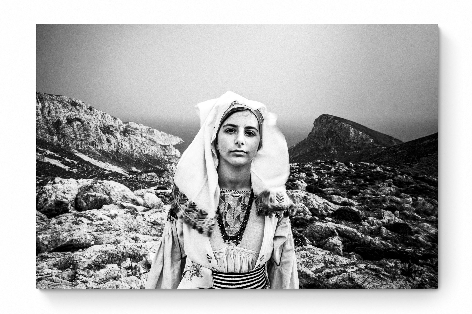 Black and White Photography Wall Art Greece | Girl wearing the traditional costume of Tilos island at a windy cliff Dodecanese Greece by George Tatakis - whole photo