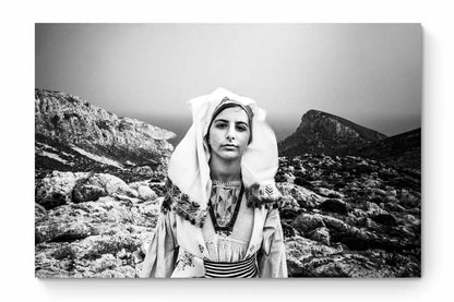 Black and White Photography Wall Art Greece | Girl wearing the traditional costume of Tilos island at a windy cliff Dodecanese Greece by George Tatakis - whole photo