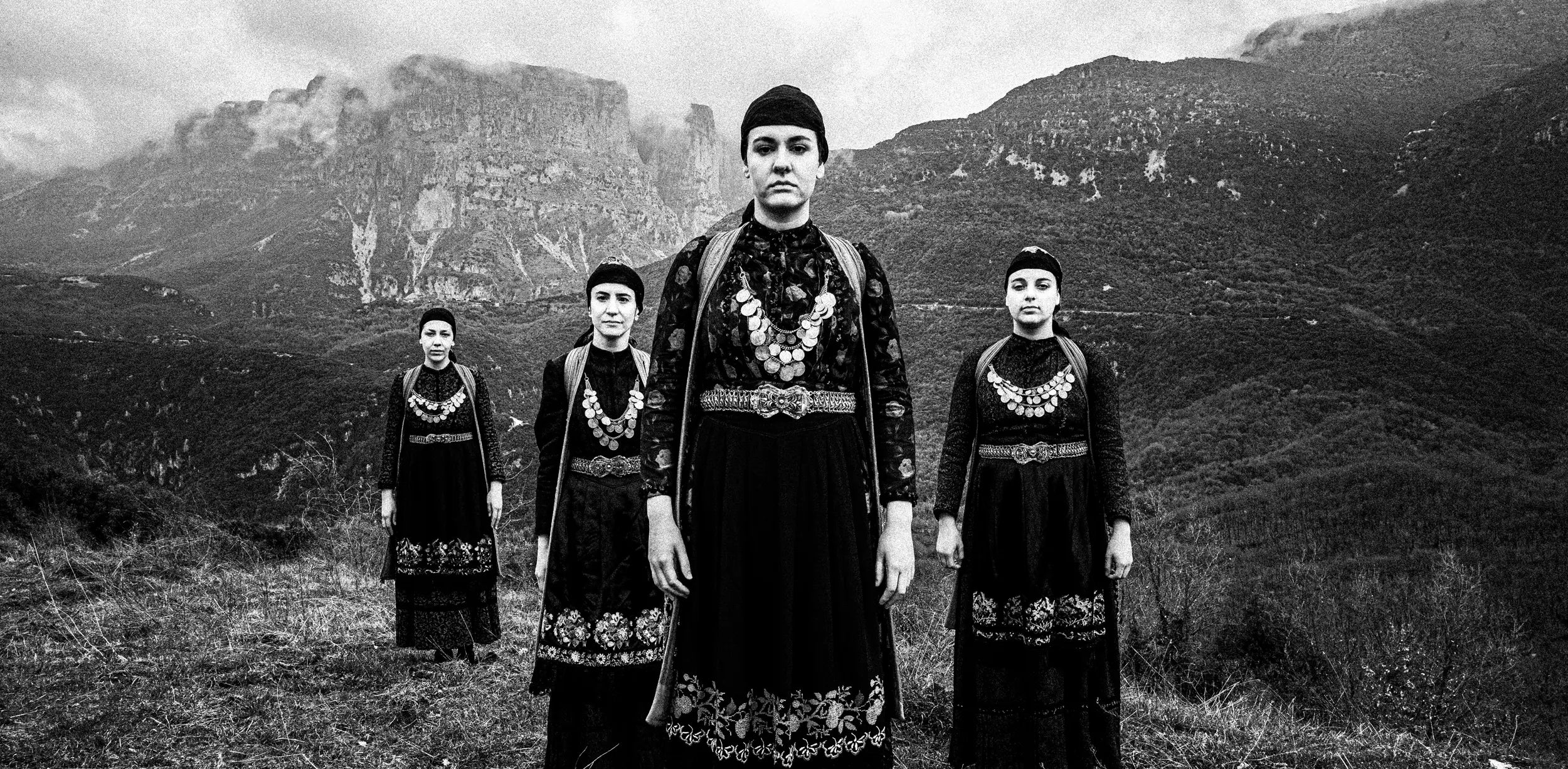 Women in folklore dresses at Zagori, Greece. Black and white photograph by George Tatakis