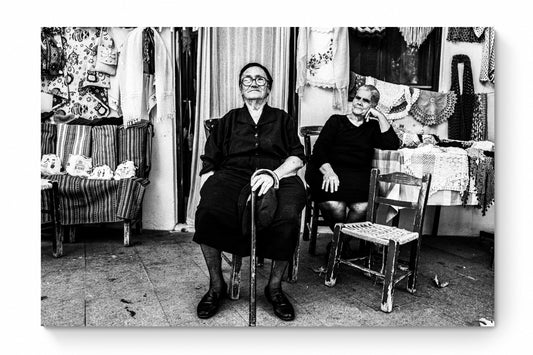 Black and White Photography Wall Art Greece | Two ladies in front of a local shop Anogia Crete by George Tatakis - whole photo