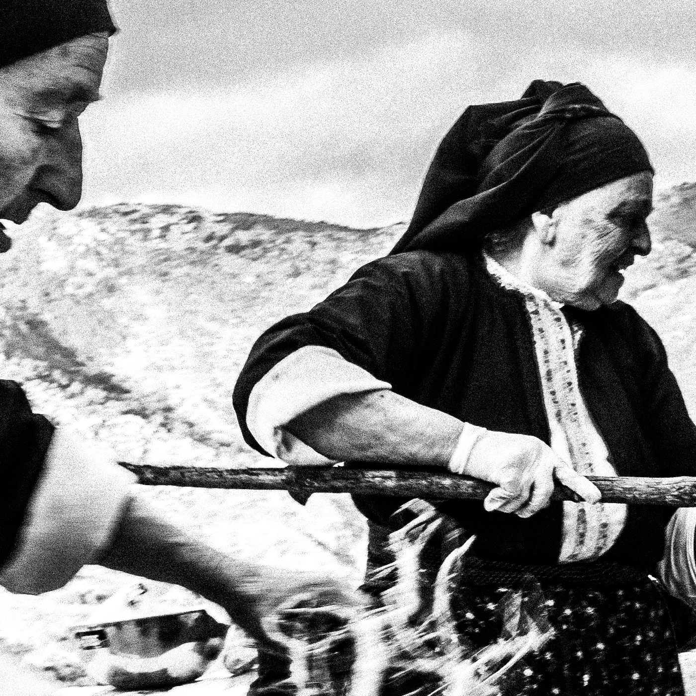 Black and White Photography Wall Art Greece | Women lighting up the wood oven Olympos Karpathos Dodecanese by George Tatakis - detailed view