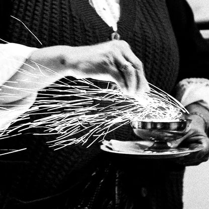 Black and White Photography Wall Art Greece | Woman with sparks during the Litany of Epitaphios Olympos Karpathos Dodecanese by George Tatakis - detailed view