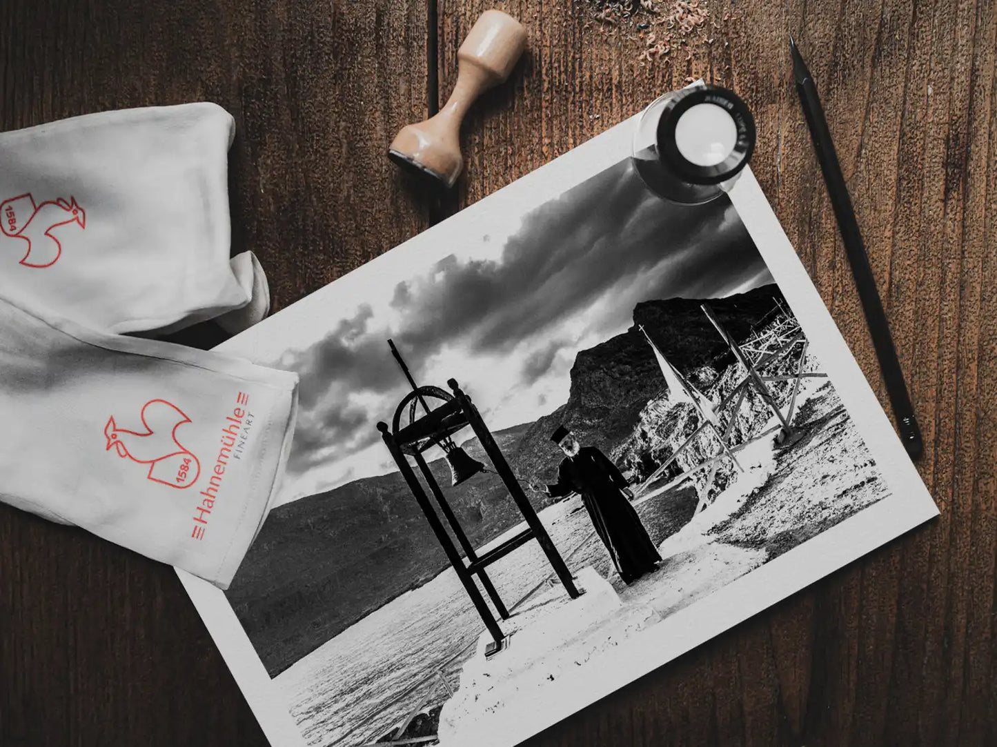 Black and White Photography Wall Art Greece | Priest striking the bell at St. John celebration in Vrykounta Olympos Karpathos Dodecanese by George Tatakis - photo print on table