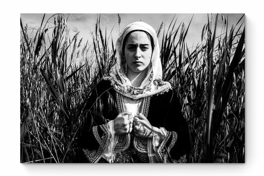 Black and White Photography Wall Art Greece by George Tatakis | A woman in the costume of Kymi in a field of straws, Euboea island - whole photo