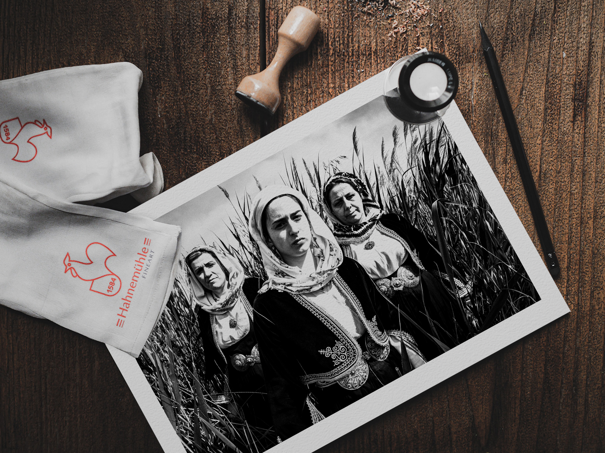 Black and White Photography Wall Art Greece by George Tatakis | Three women in the costume of Kymi in a field of straws, Euboea island - photo print on table