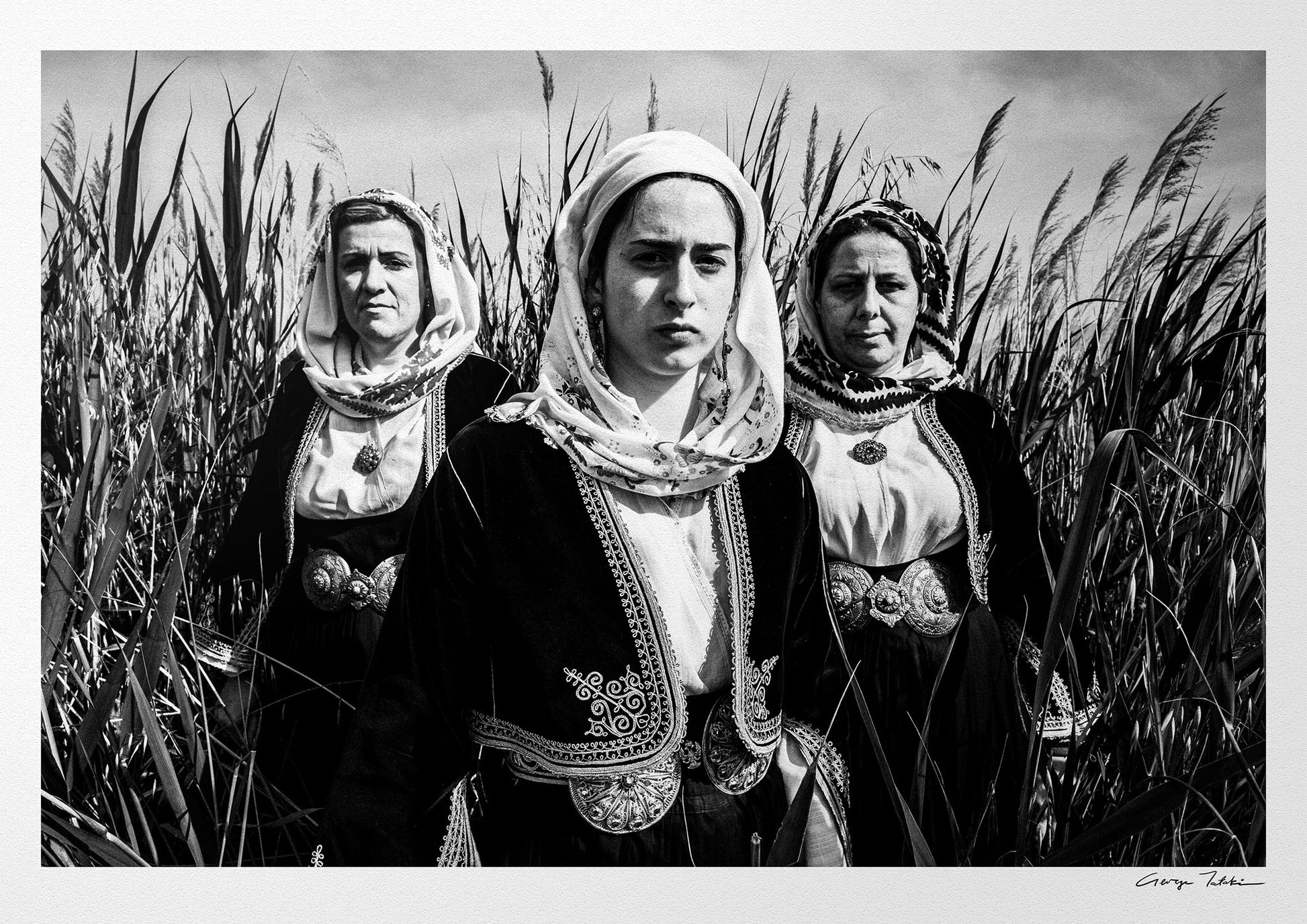 Black and White Photography Wall Art Greece by George Tatakis | Three women in the costume of Kymi in a field of straws, Euboea island