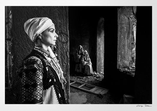 Woman in profile and two supporting figures in Kyparissia costumes, Peloponnese, Greece. Black and white photography by George Tatakis.