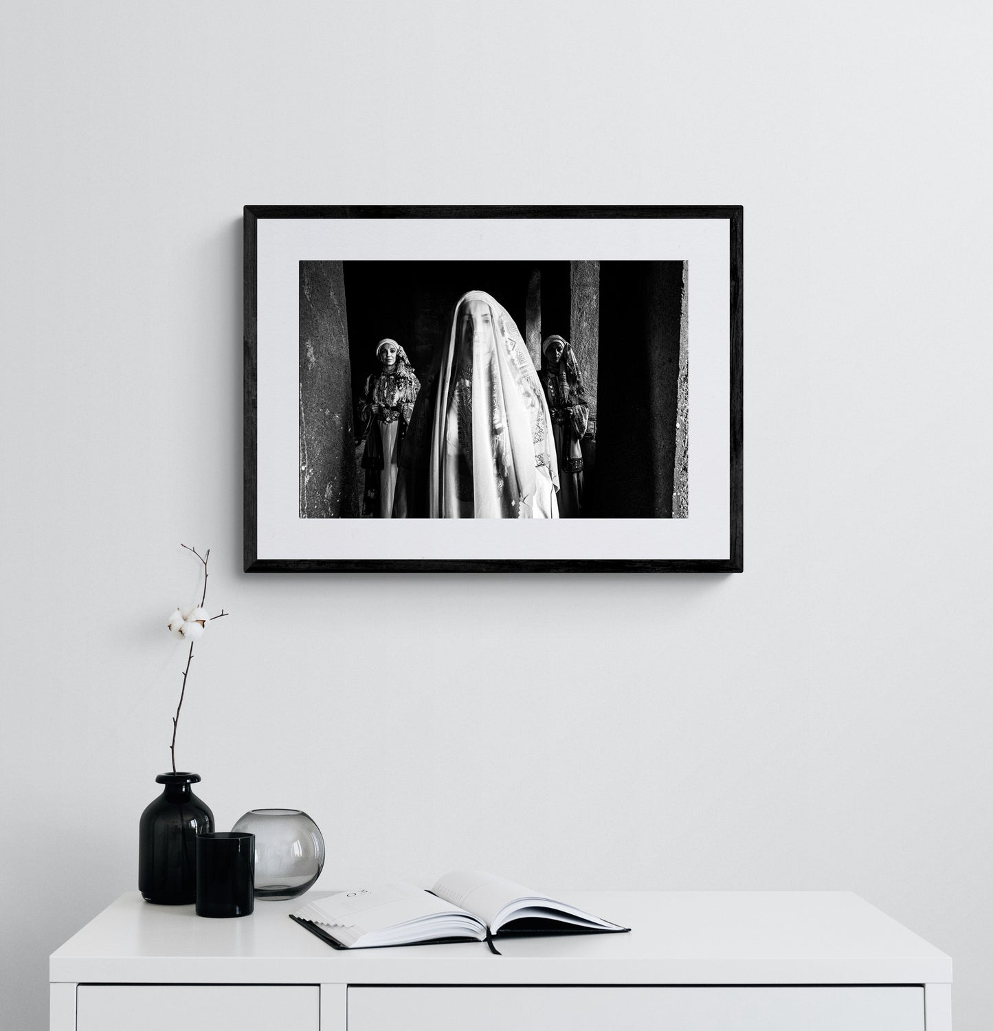 Veiled bride with two supporting figures in Kyparissia local costumes. Peloponnese, Greece. Black and white photography framed on a wall by George Tatakis.