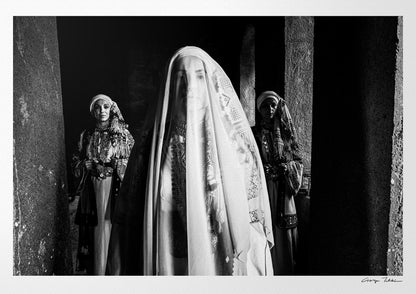 Veiled bride with two supporting figures in Kyparissia local costumes. Peloponnese, Greece. Black and white photography by George Tatakis.