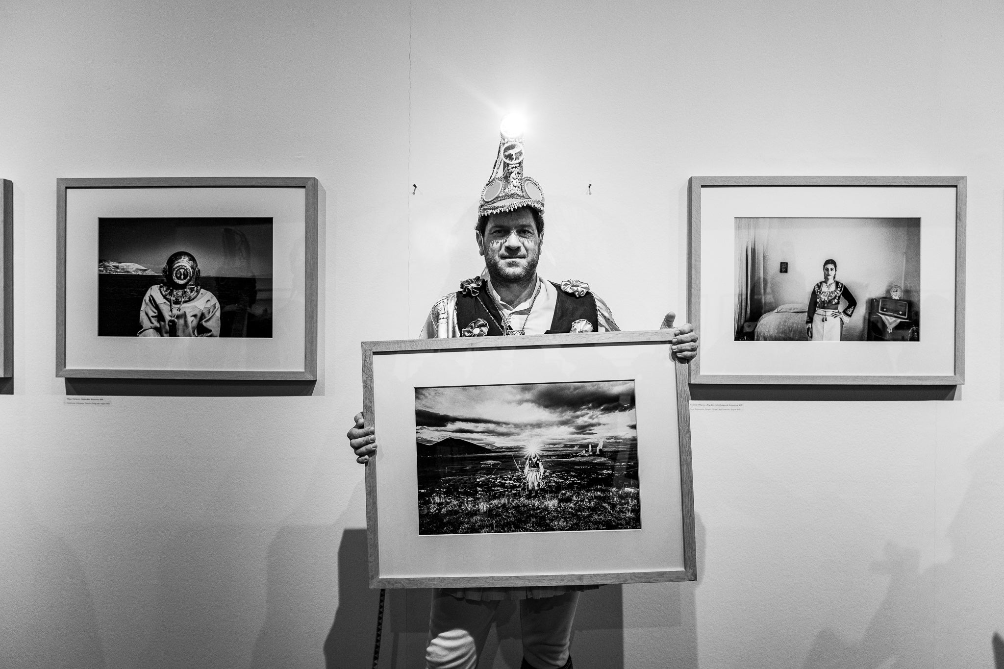 Holding a framed artwork by photographer George Tatakis, at the Benaki Museum in Athens, Greece