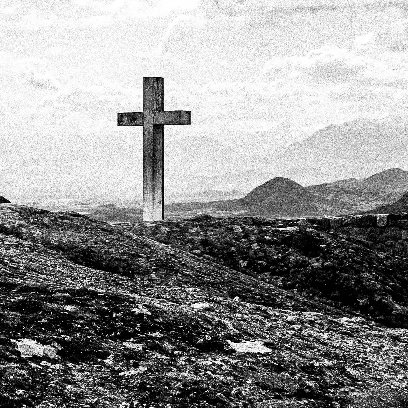 Cross on a rock at Meteora. Black-and-white photography artwork by George Tatakis from the project Chorōs. Close-up detail.