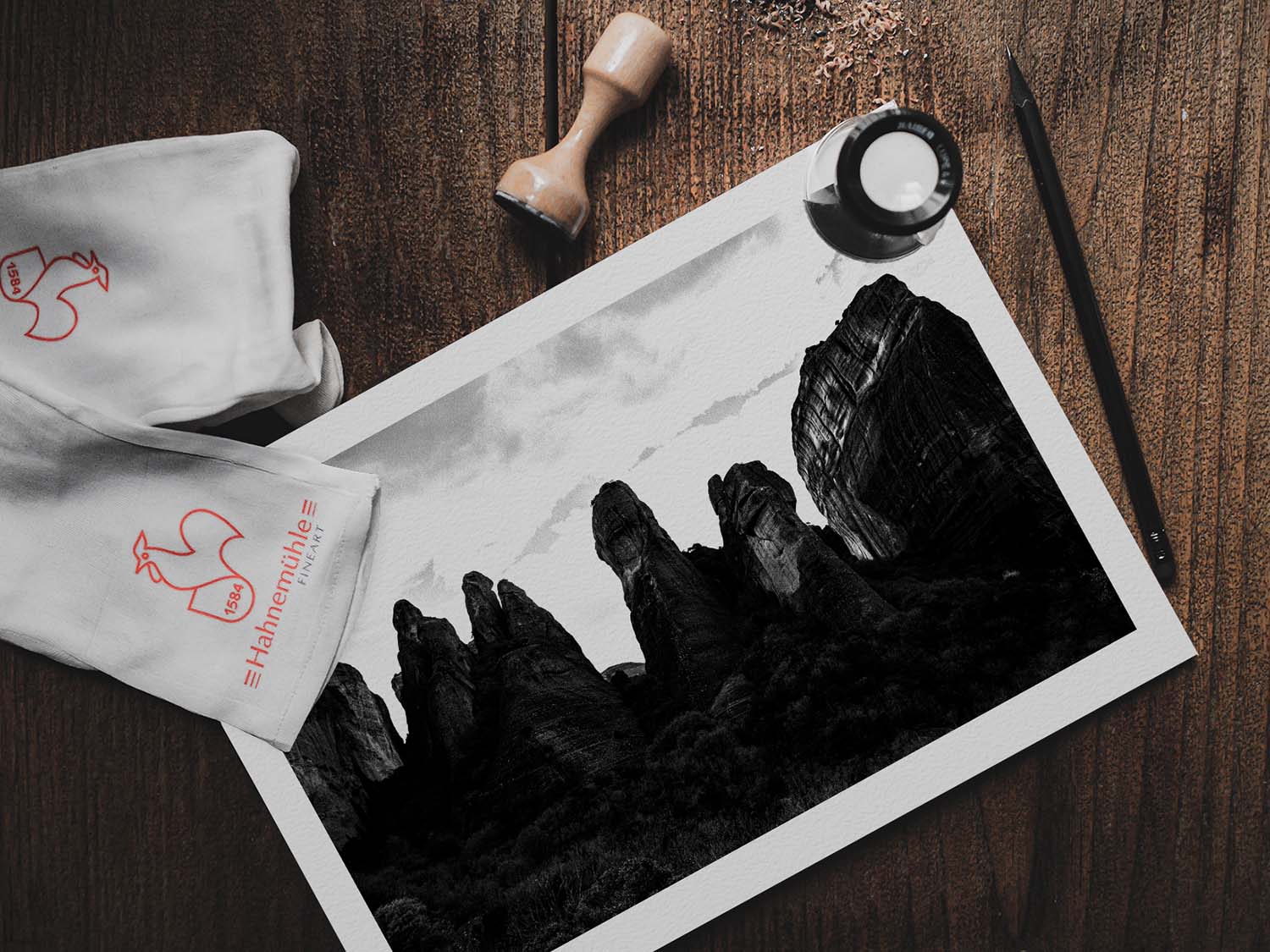 Meteora pillar formations. Black-and-white photography print by George Tatakis, from the project Chorōs. Print on a wooden table