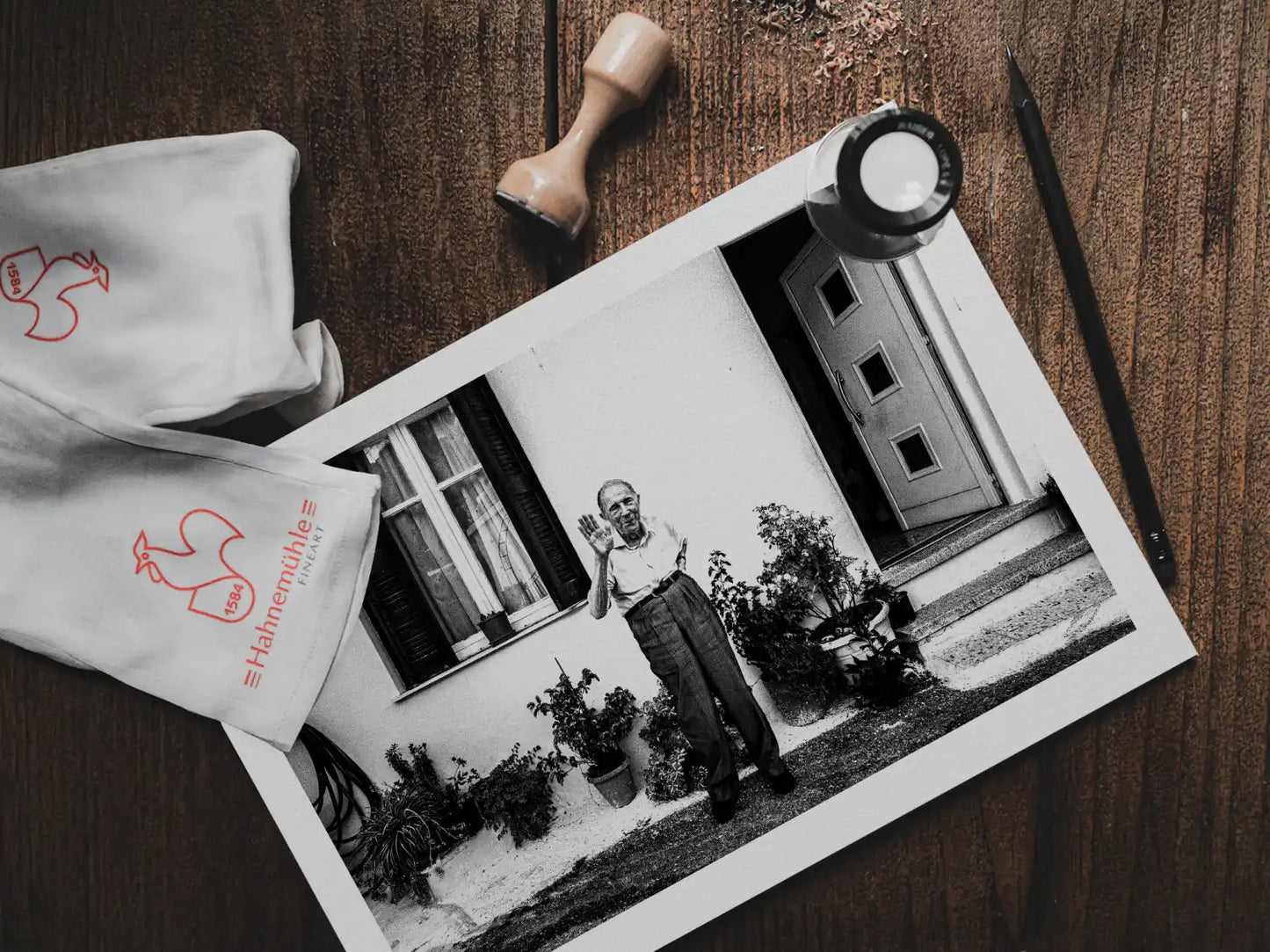 Black and White Photography Wall Art Greece | A man waving at Spilli Rethymnon Crete - print on table