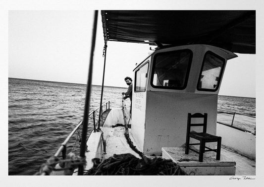 Black and White Photography Wall Art Greece | Fisherman with nets on his boat in Diafani Olympos Karpathos Dodecanese by George Tatakis