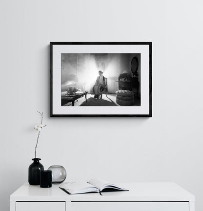 Sitting portrait of a woman in the urban costume of Kalamata, shot at the Lyceum Club of Greek Women. Peloponnese, Greece. Black and white photography framed on a wall by George Tatakis.