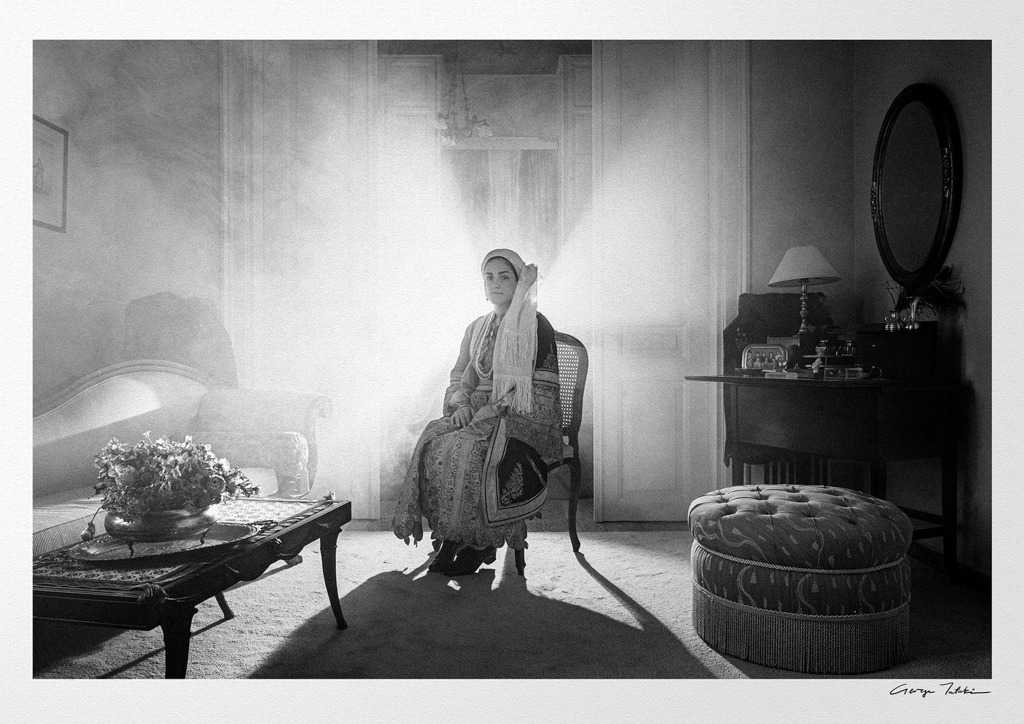 Sitting portrait of a woman in the urban costume of Kalamata, shot at the Lyceum Club of Greek Women. Peloponnese, Greece. Black and white photography by George Tatakis.
