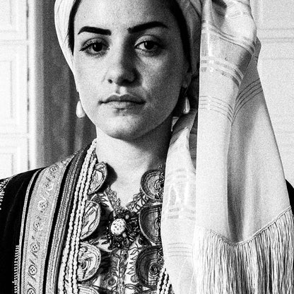 Portrait of a woman in the urban dress of Kalamata at the Lyceum Club of Greek Women. Peloponnese, Greece. Black and white photography close-up detail by George Tatakis.