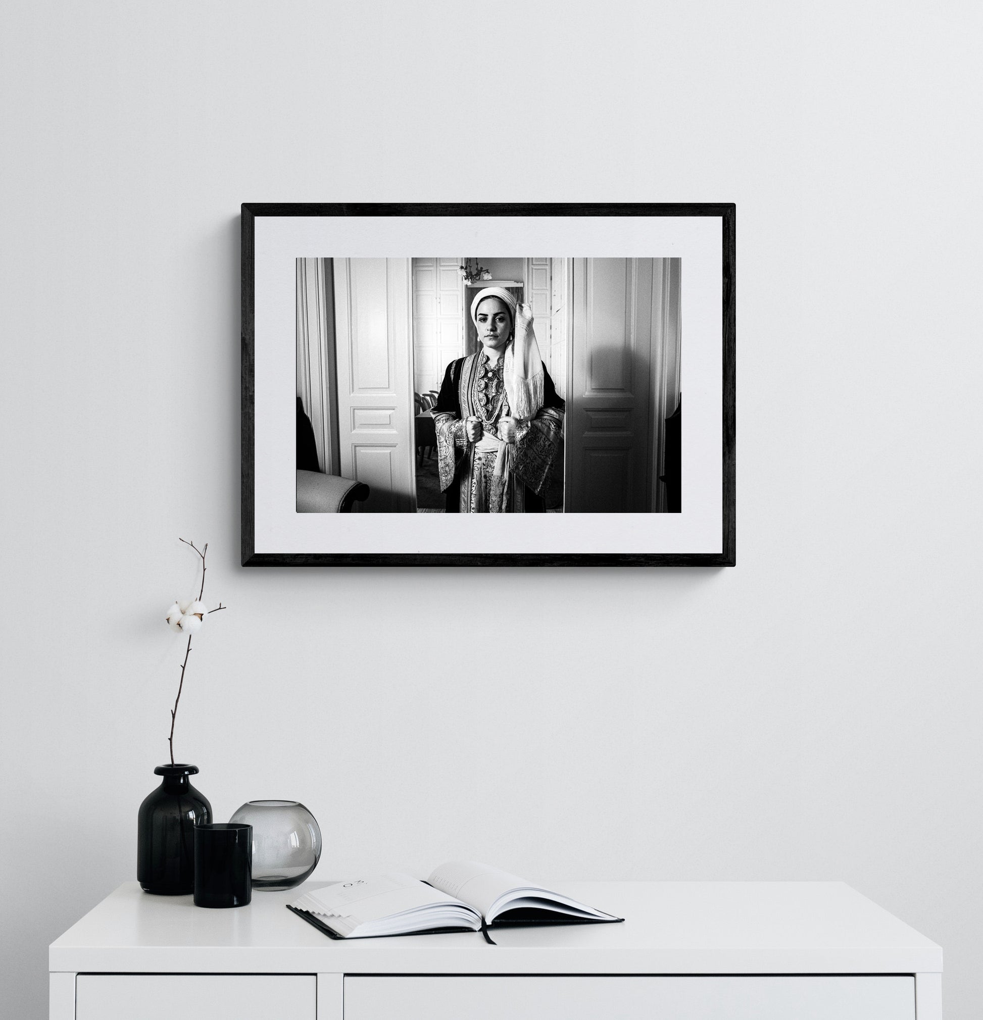 Portrait of a woman in the urban dress of Kalamata at the Lyceum Club of Greek Women. Peloponnese, Greece. Black and white photography framed on a wall by George Tatakis.