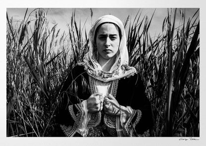 Black and White Photography Wall Art Greece by George Tatakis | A woman in the costume of Kymi in a field of straws, Euboea island