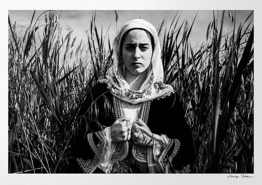 Black and White Photography Wall Art Greece by George Tatakis | A woman in the costume of Kymi in a field of straws, Euboea island