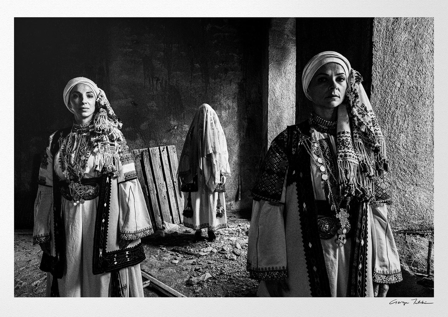 Veiled bride and two women in Kyparissia costumes, Peloponnese, Greece. Black and white photography by George Tatakis.