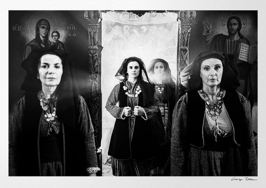 Four women in Alagonia local costumes at the church of the Mandraki Monastery, Alagonia, Peloponnese, Greece. Black and white photography by George Tatakis.