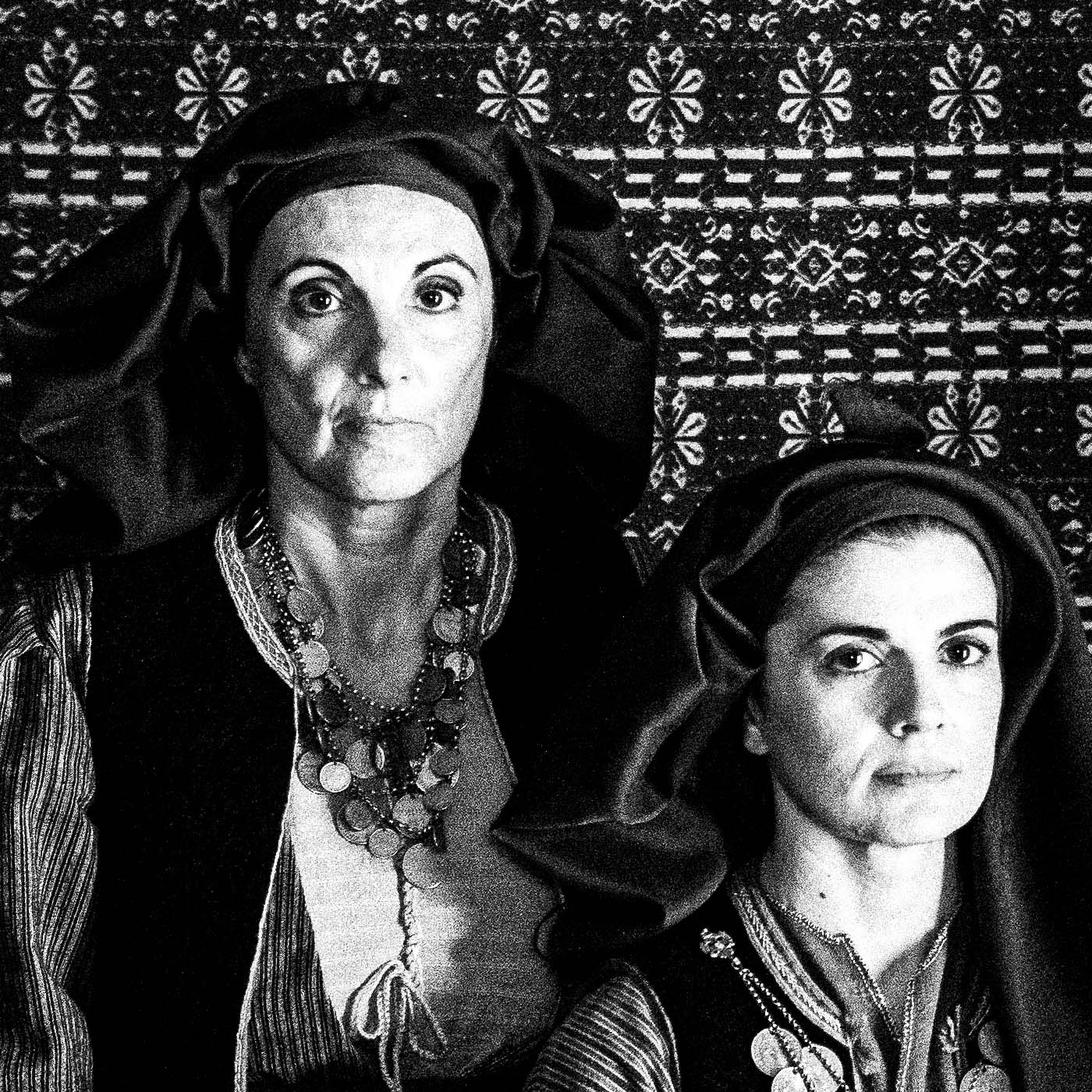 Three women in Alagonia local costumes. Nedoussa, Peloponnese, Greece. Black and white photography close-up detail by George Tatakis.