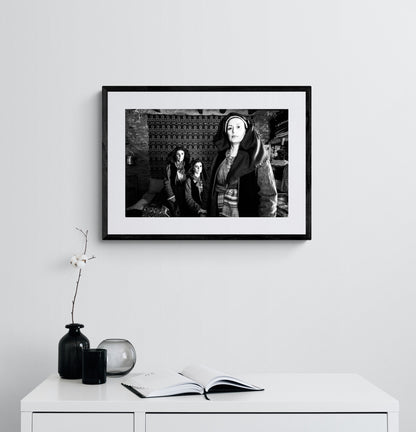 Three women in Alagonia local costumes. Nedoussa, Peloponnese, Greece. Black and white photography framed on a wall by George Tatakis.
