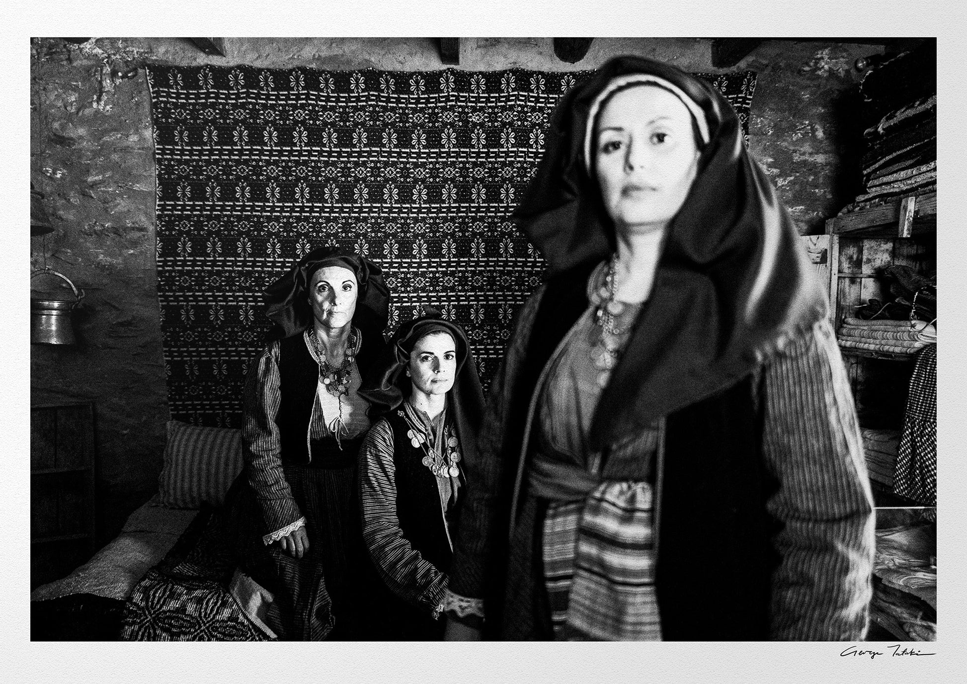 Three women in Alagonia local costumes. Nedoussa, Peloponnese, Greece. Black and white photography by George Tatakis.