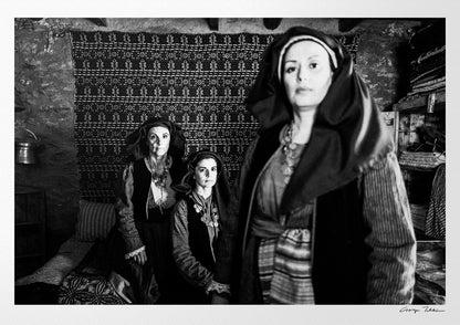 Three women in Alagonia local costumes. Nedoussa, Peloponnese, Greece. Black and white photography by George Tatakis.