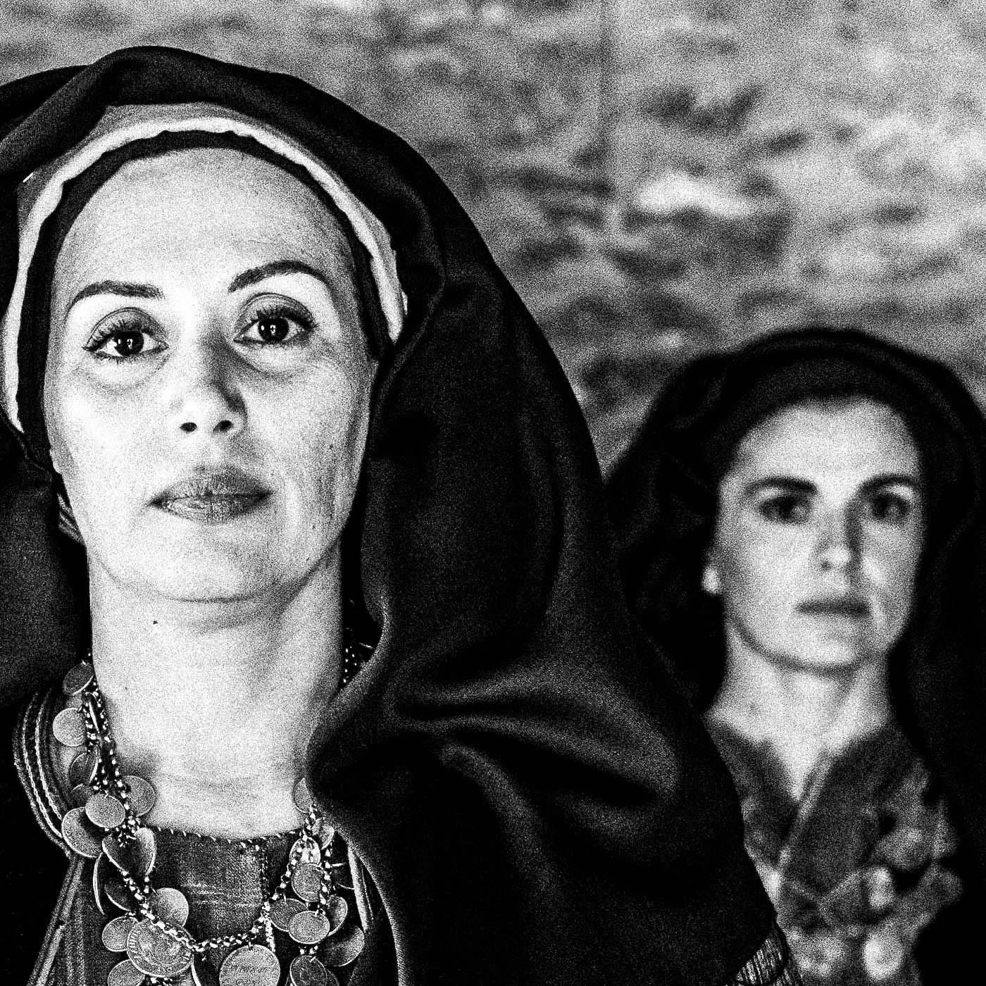 Three women in local dresses at Nikitaras house, Nedoussa, Alagonia, Peloponnese, Greece. Black and white photography close-up detail by George Tatakis.