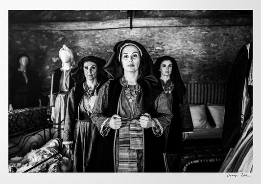 Three women in local dresses at Nikitaras house, Nedoussa, Alagonia, Peloponnese, Greece. Black and white photography by George Tatakis.