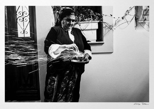 Black and White Photography Wall Art Greece | Woman with sparks during the Litany of Epitaphios Olympos Karpathos Dodecanese by George Tatakis
