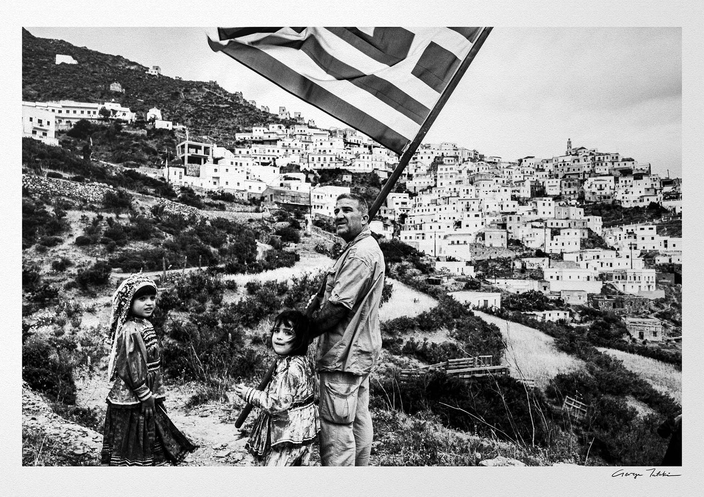 Black and White Photography Wall Art Greece | Carrying the Greek flag in Olympos Karpathos Dodecanese by George Tatakis
