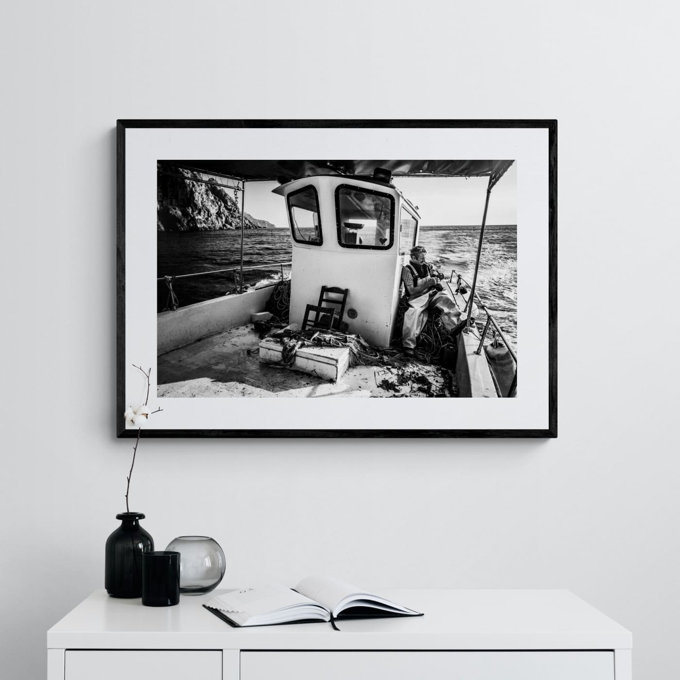 Black and White Photography Wall Art Greece | Fisherman smoking on his boat in Diafani Olympos Karpathos Dodecanese by George Tatakis - single framed photo