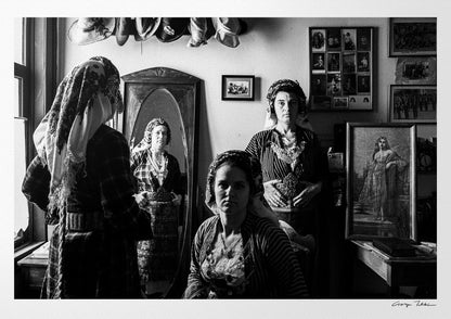 A group of women with a mirror wearing the local costumes of Soufli, Thrace, Greece. Black and white photography by George Tatakis.