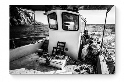 Black and White Photography Wall Art Greece | Fisherman smoking on his boat in Diafani Olympos Karpathos Dodecanese by George Tatakis - whole photo